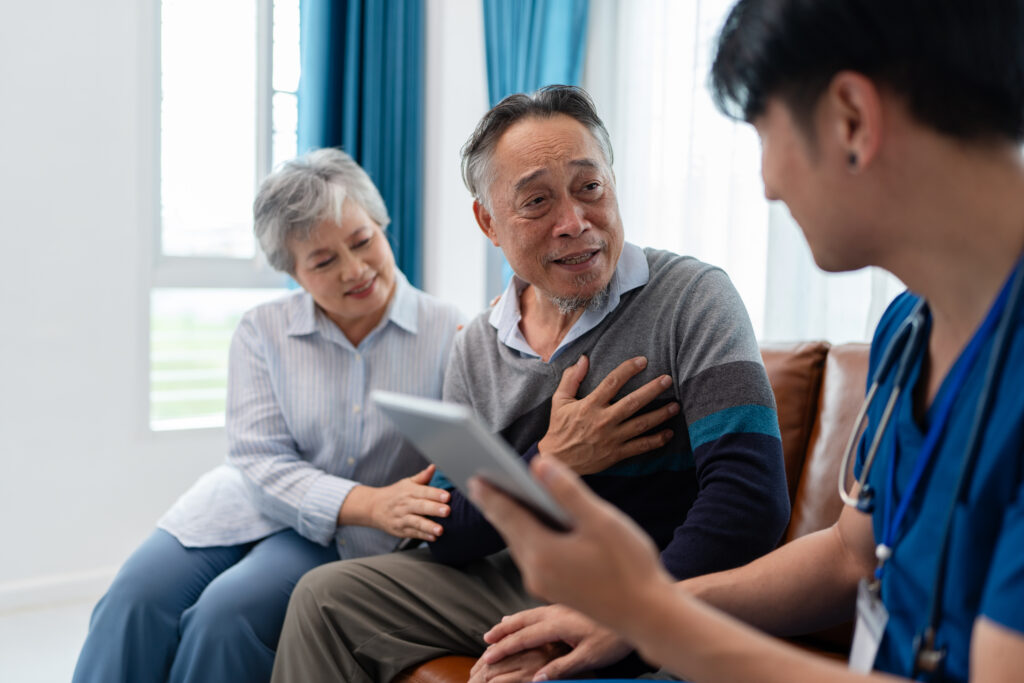Male patient shows medical staff concern while caregiver watches